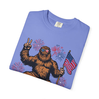 Patriotic Sasquatch Graphic T-Shirt — Bigfoot Holding American Flag, Fireworks 4th of July Tee