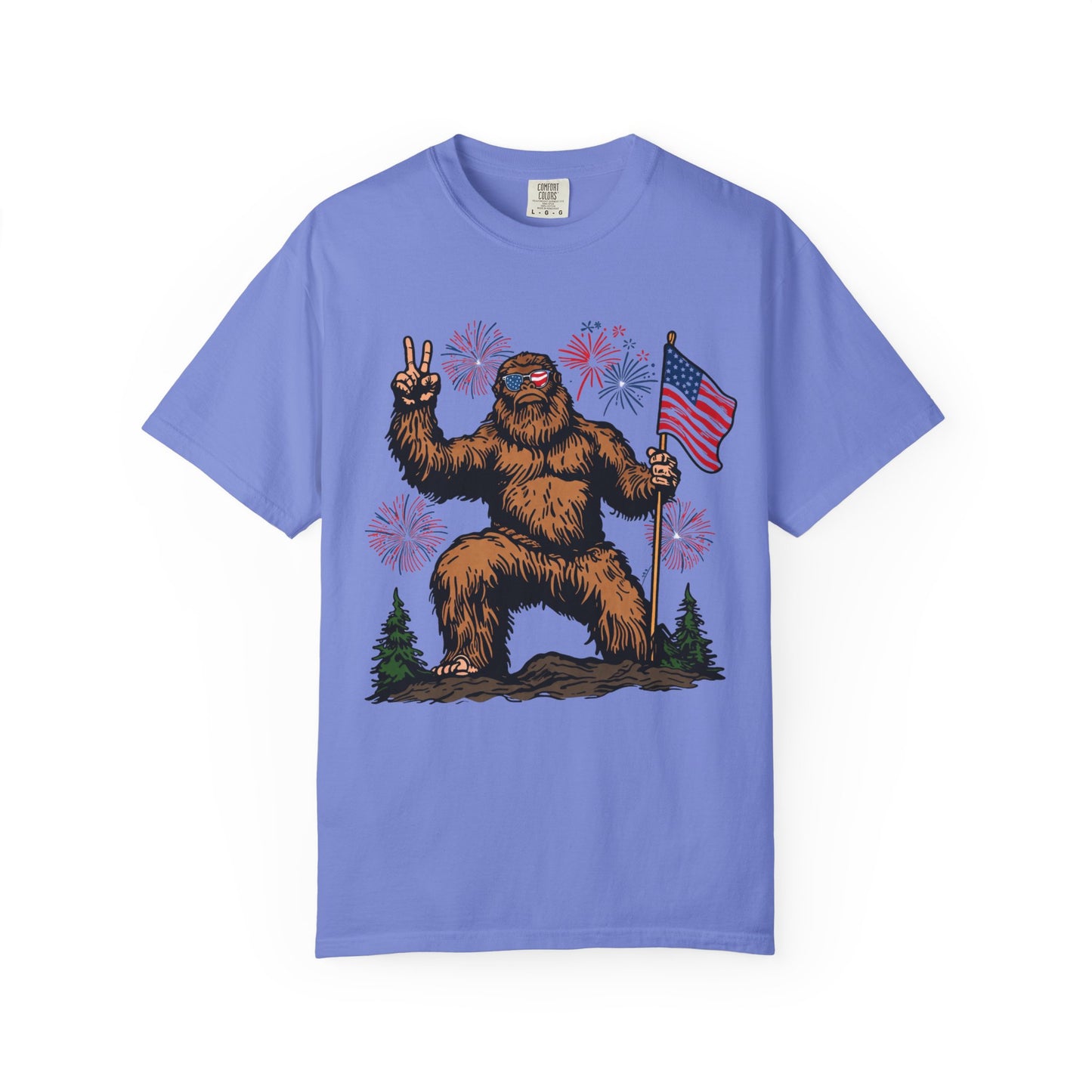 Patriotic Sasquatch Graphic T-Shirt — Bigfoot Holding American Flag, Fireworks 4th of July Tee