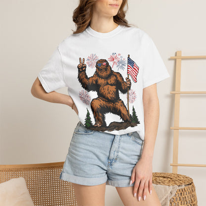 Patriotic Sasquatch Graphic T-Shirt — Bigfoot Holding American Flag, Fireworks 4th of July Tee