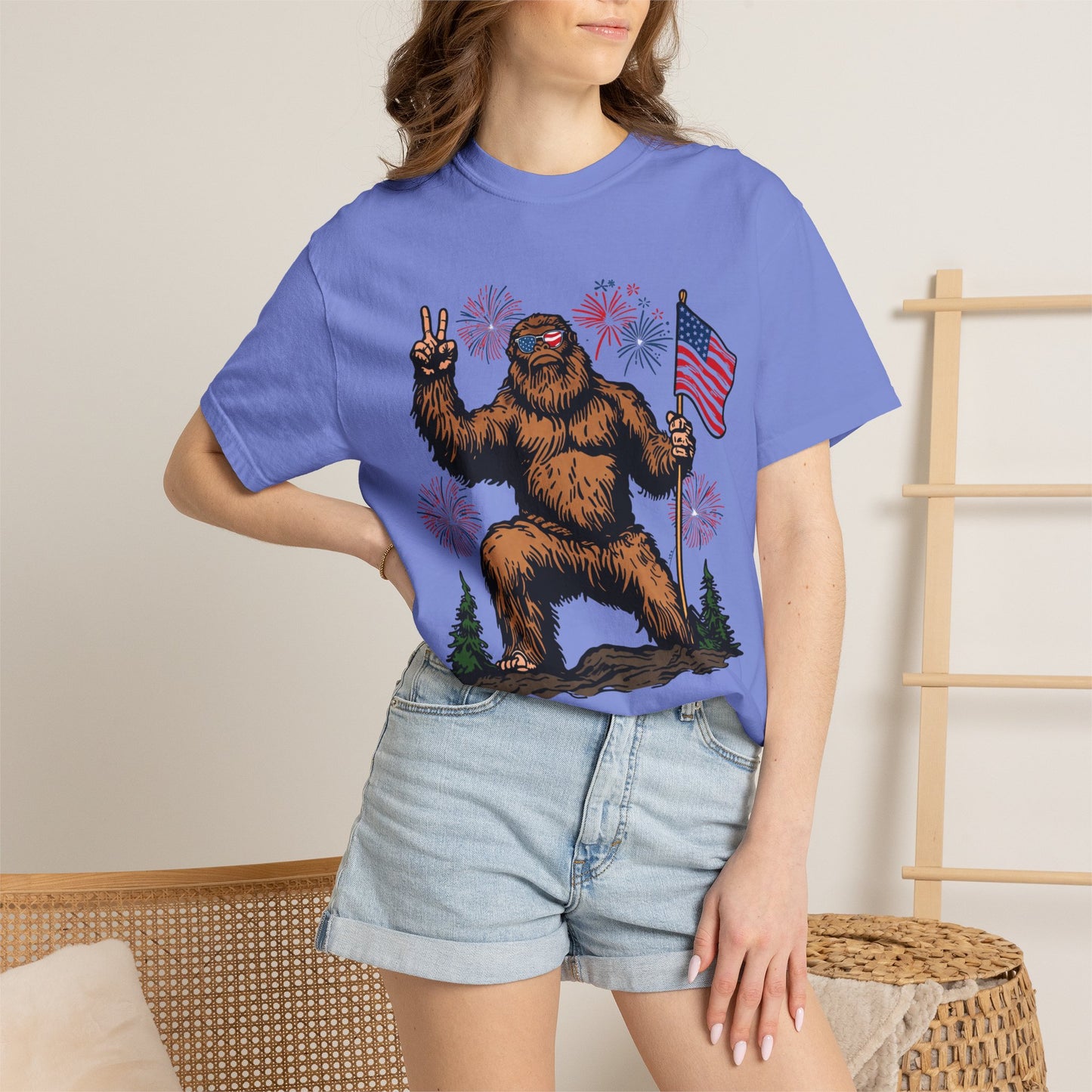 Patriotic Sasquatch Graphic T-Shirt — Bigfoot Holding American Flag, Fireworks 4th of July Tee