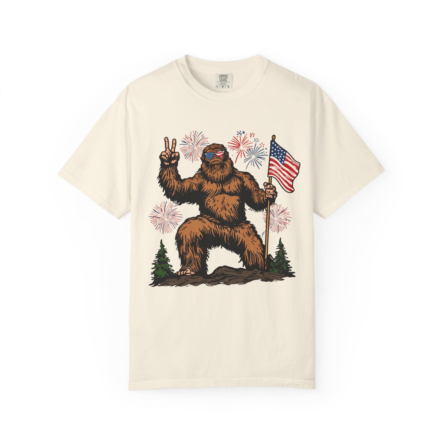 Patriotic Sasquatch Graphic T-Shirt — Bigfoot Holding American Flag, Fireworks 4th of July Tee