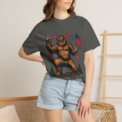 Patriotic Sasquatch Graphic T-Shirt — Bigfoot Holding American Flag, Fireworks 4th of July Tee